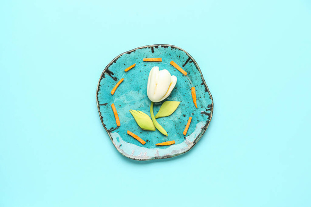 Plate with children's breakfast in shape of tulip on blue background - Photo, Image