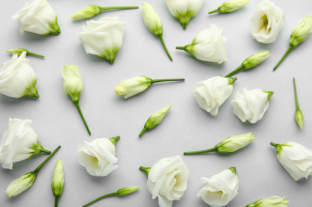 Composition with delicate eustoma flowers on light background - Photo, Image