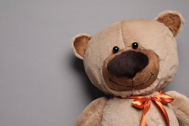 Cute teddy bear on gray background, top view. Space for text - Photo, Image