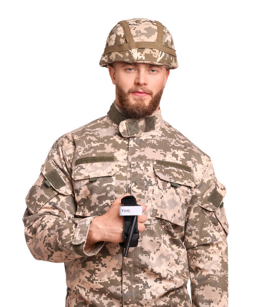 Soldier in military uniform holding medical tourniquet on white background - Foto, imagen