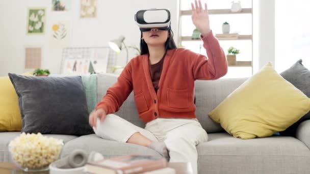 VR, gaming goggles and woman on couch for metaverse, futuristic video games and cyberpunk experience at home. Virtual reality glasses, digital high tech and happy young person or 3d gamer on sofa. - Footage, Video