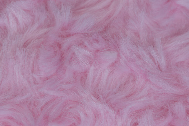 Roze luxe wol natuurlijke pluizige bont wol huid textuur close-up gebruik voor achtergrond en behang - Foto, afbeelding