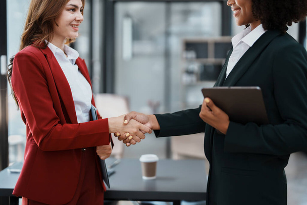 Multi ethnic business Financial shaking hands, Successful businessmen handshaking after good deal. Business Finishing up meeting contract concept. - Photo, Image