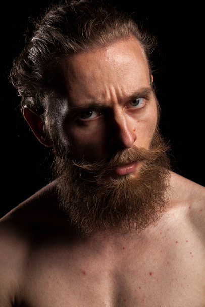 Портрет татуйованого бородатого хіпстера на чорному тлі в студійній фотографії. Вираз і мода
 - Фото, зображення