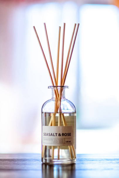 An aroma diffuser with aromatic oil and sticks in the room near the window creates an atmosphere of peace and comfort - Fotografie, Obrázek