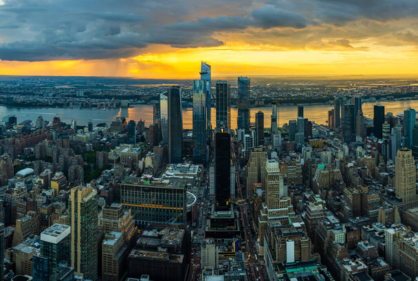 A rain storm over the Hudson Yards in New York City during beautiful sunset. - Φωτογραφία, εικόνα