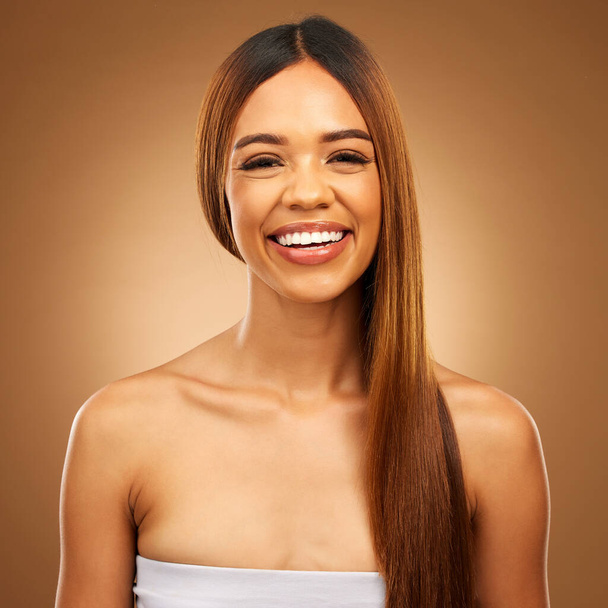 Smile, beauty and hair care portrait of woman in studio for growth, color shine or healthy texture. Happy female face for haircare, natural makeup and hairdresser or salon on brown background. - Fotoğraf, Görsel