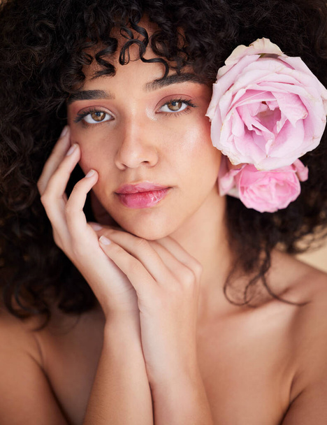 Flowers, makeup and portrait of woman for beauty, cosmetics and haircare for wellness, glamour and glow. Salon, luxury spa and serious face of girl for natural, skincare or facial treatment in studio. - Fotó, kép