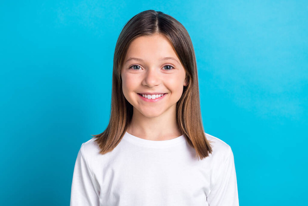 Photo of pretty adorable little girl wear white shirt smiling showing white teeth isolated blue color background. - Фото, изображение