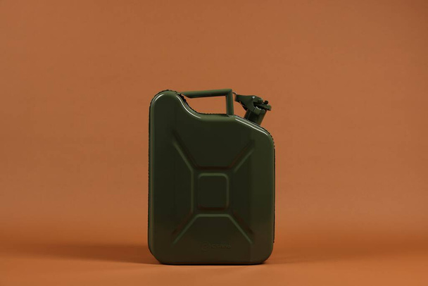 New khaki metal canister on brown background - Photo, image