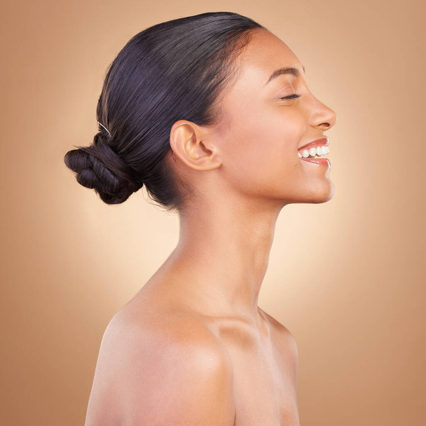Face, beauty and profile of Indian woman with smile for wellness, healthy skin and facial treatment in studio. Dermatology skincare, luxury spa and happy girl with makeup, cosmetics and confidence. - Foto, Imagem
