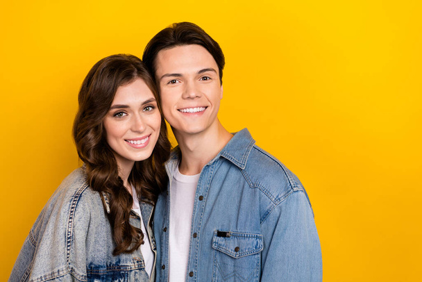Portrait of two idyllic peaceful partners toothy smile touch heads empty space isolated on yellow color background. - Foto, immagini