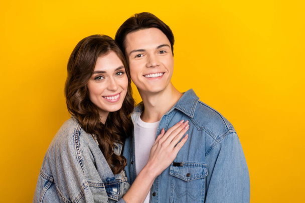Portrait of lovely positive partners cuddle beaming smile good mood isolated on yellow color background. - Foto, imagen
