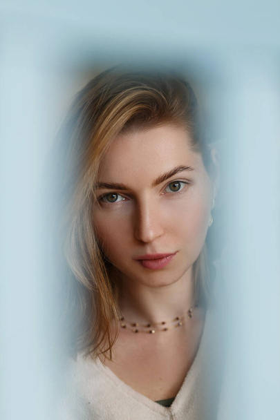 Woman portrait natural beautiful. Shoot with a blue blurred frame  - Фото, изображение