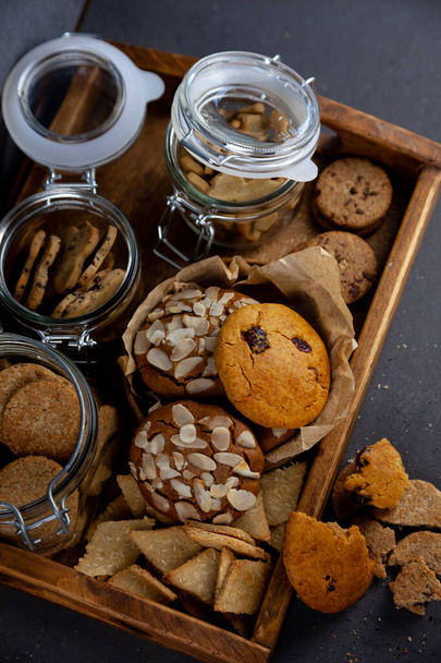Set of different cookies. Food background. Homemade breakfast cookie top view. Sweet almonds chips snack. Bakery cook. Bake a cake. Coconut, spelled raisins. - Photo, Image