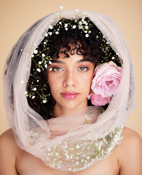 Veil, flowers and portrait of woman for beauty, cosmetics and makeup for wellness, glamour and glow in studio. Spring aesthetic, style and serious face of girl for fashion, skincare and facial care. - Fotografie, Obrázek