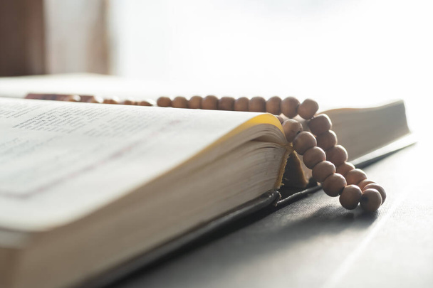 Holy book and prayer beads for Muslims. concept of the Koran and prayer beads - Fotó, kép