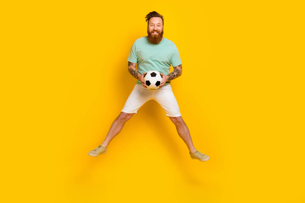 Full body photo of overjoyed football fan support favorite club jumping goalkeeper fifa world cup championship isolated on yellow color background. - 写真・画像
