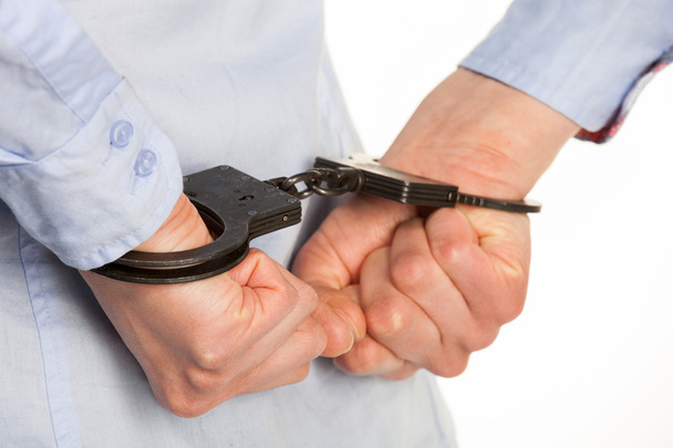 Чоловічі руки в наручниках
 - Фото, зображення