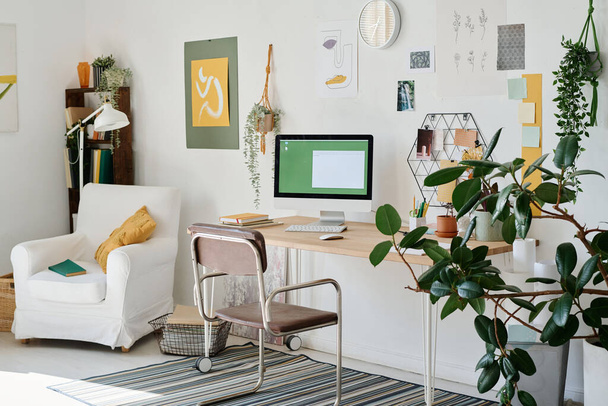 Parte de la sala de estar con el lugar de trabajo de diseñador web independiente u otra profesión creativa por la pared con composiciones hechas a mano - Foto, Imagen