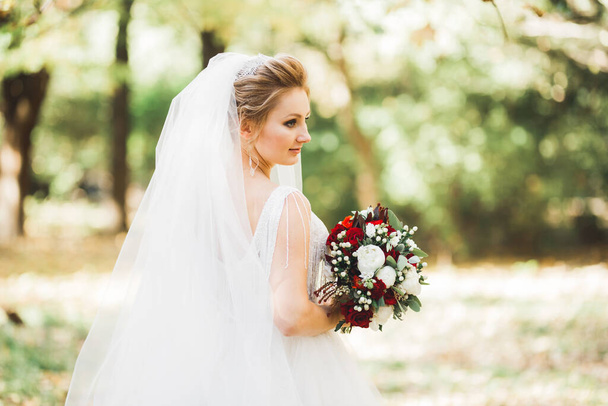 Beautiful luxury bride in elegant white dress. - Fotó, kép