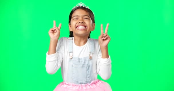 Peace, fun and hand gesture with a girl on a green screen background in studio feeling silly or carefree. Portrait, dance and emoji with an adorable little female child looking goofy or playful. - Footage, Video