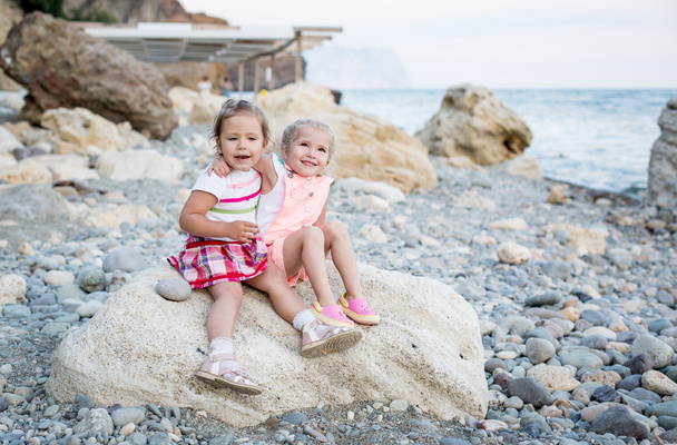 two happy toddler girl on the beach  - Фото, изображение