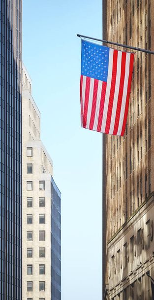 American flag with buildings in background, selective focus, New York City, USA. - Foto, Imagem