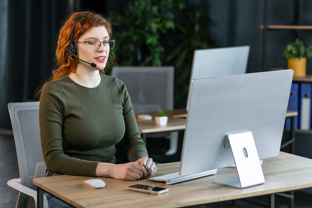 Female customer support operator with headset and smiling. - Photo, Image