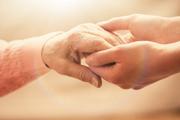 Old and young holding hands - Foto, imagen