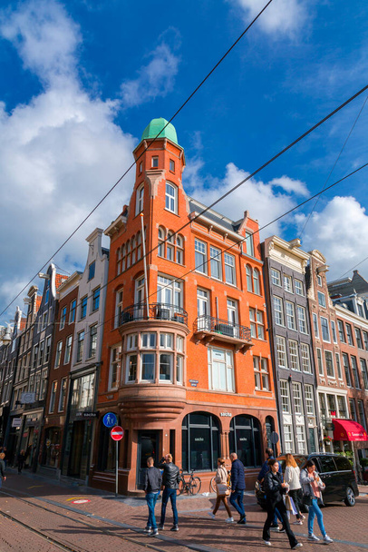 Amsterdam, the Netherlands - October 11, 2021: Street view and generic architecture in Amsterdam with typical Dutch style buildings. Amsterdam is one of Europe's most visited tourist destinations. - Fotografie, Obrázek