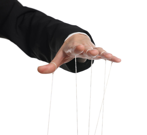 Woman pulling strings of puppet on white background, closeup - Photo, Image