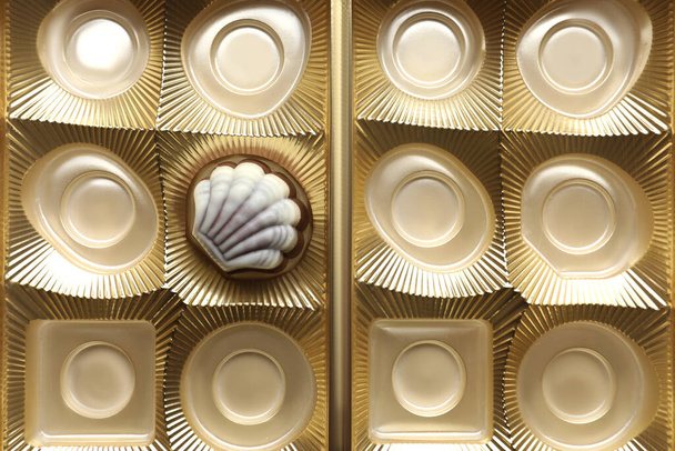 Partially empty box of chocolate candies as background, top view - Foto, afbeelding