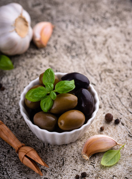Bowl with Greek green and black spicy pickled olives - Fotó, kép