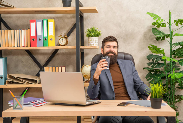 happy mature man freelancer use online computer communication at office holding coffee, business communication. - Valokuva, kuva