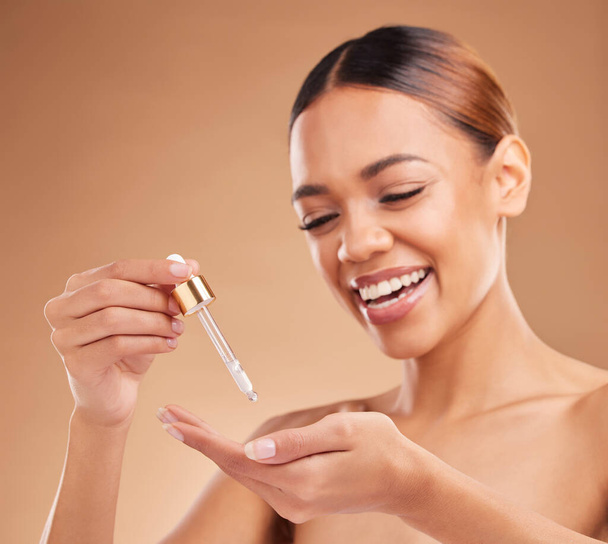 Beauty serum, happy or model woman in studio on beige background for facial skincare in studio. Face smile or natural girl smiling with essential oils or glowing luxury self care hydration product. - Foto, imagen