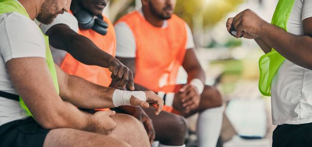 Injury, sports and a man with a bandage at rugby, wrapping wrist and accident at a game. Team, playing and men protecting a hand of a player after a broken bone during sport competition or match. - Zdjęcie, obraz