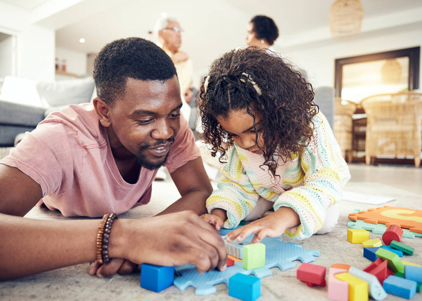 Family, building blocks and dad with girl on floor in living room for playing, bonding and quality time. Love, educational toys and happy father with child with toys, relaxing and creative activity. - Photo, Image