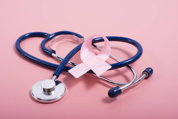 Stethoscope and pink ribbon on pink background as breast cancer awareness symbols - Φωτογραφία, εικόνα