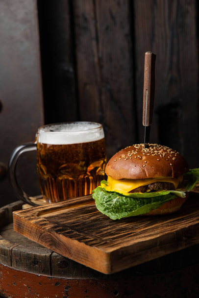 A burger and a mug of beer - Φωτογραφία, εικόνα