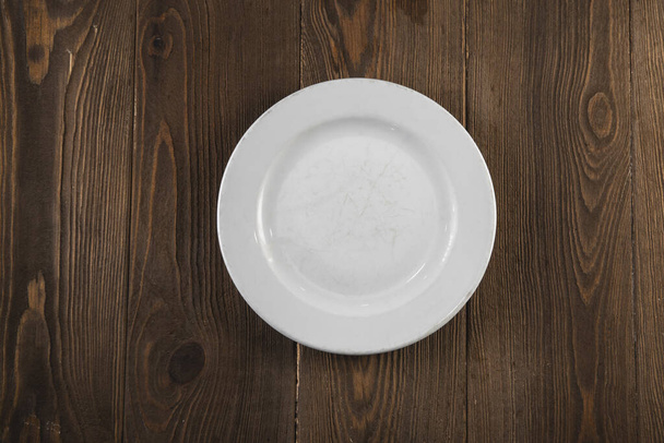 empty white plate on wooden background . - Foto, immagini