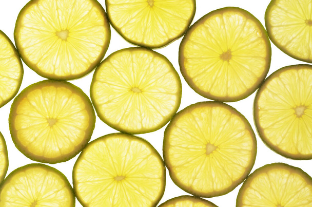 Lime slices over white background - Foto, afbeelding