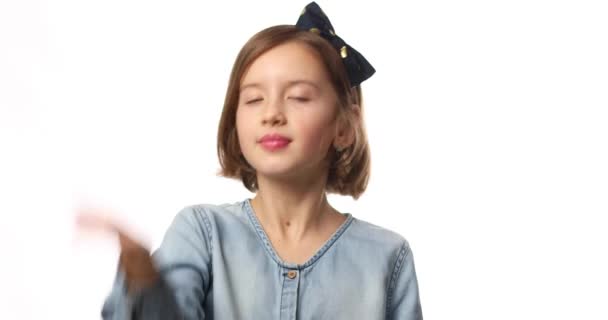 Teen girl child wearing jeans dress put hand on face facepalm in studio on white background, epic fail, amazed with stupid situation - Footage, Video