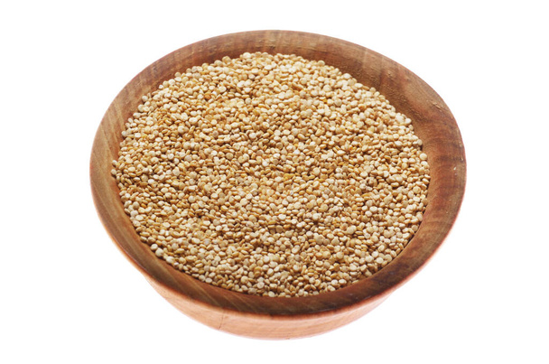Raw organic superfood gluten free quinoa seeds in wooden bowl closeup isolated on white background - Foto, Imagem