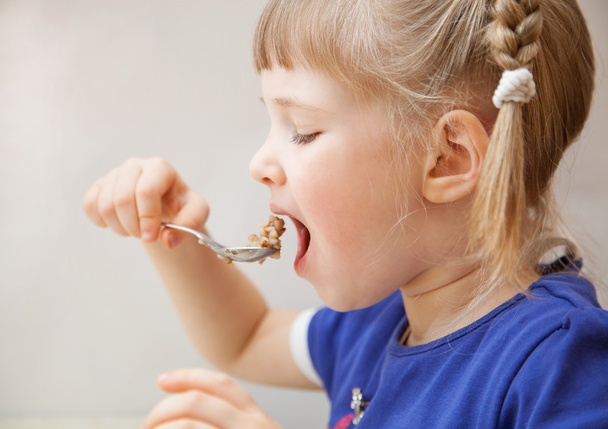 Adorable baby girl eating porridge - Фото, зображення