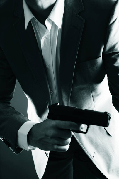 Retro secret agent with pistol revolver gun in hand in vintage crime thriller mockup cover     photo.        - Photo, Image