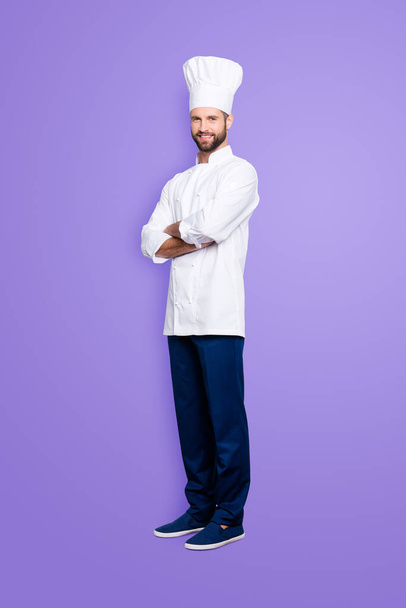 Full size body portrait of joyful positive chef cook with stubble in beret, having his arms crossed, isolated over grey background, looking at camera. - Foto, Bild