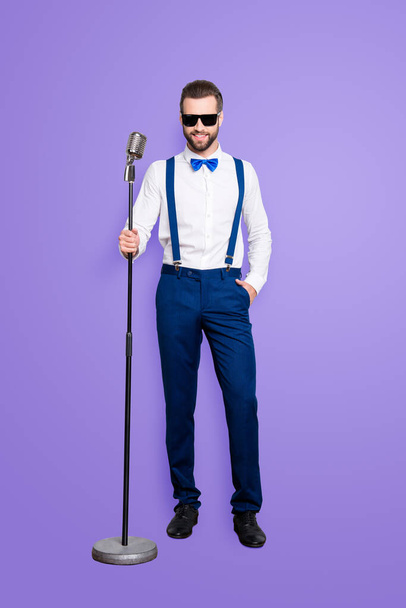 Full size full body portrait of cheerful elegant singer with bristle in blue outfit white shirt holding hand in pocket, having mic, isolated over grey background. - Φωτογραφία, εικόνα