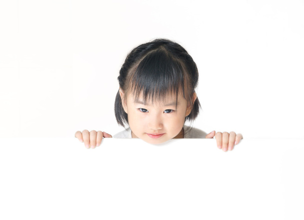 Asian little girl hiding behind white board - Photo, Image