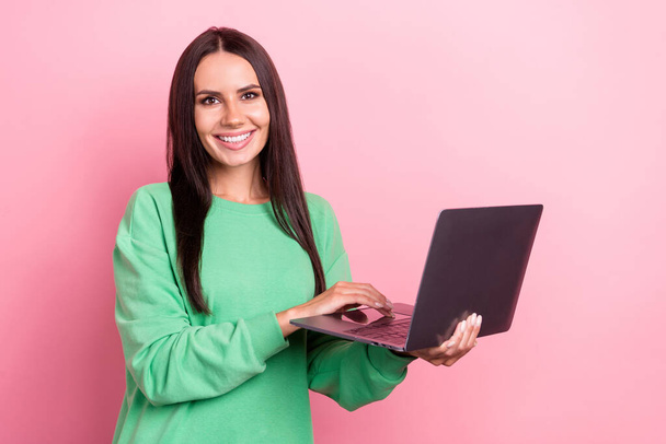 Photo of young hispanic adorable woman brunette hair wear stylish pullover hold laptop teacher online it courses isolated on pink color background. - 写真・画像